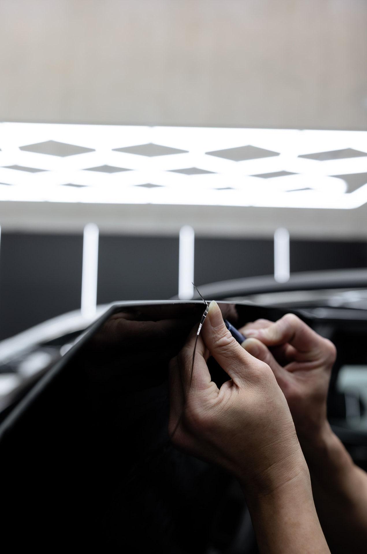 Clear Line Tints installer trimming window film precisely to the glass edge